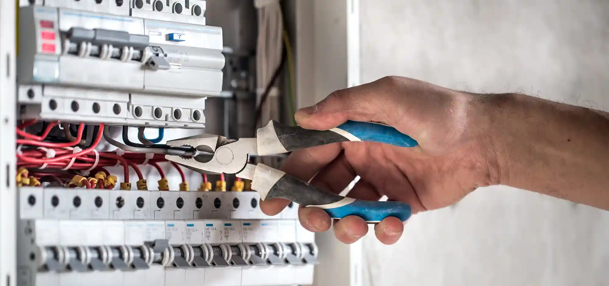 service_0001_electrical-technician-working-switchboard-with-fuses