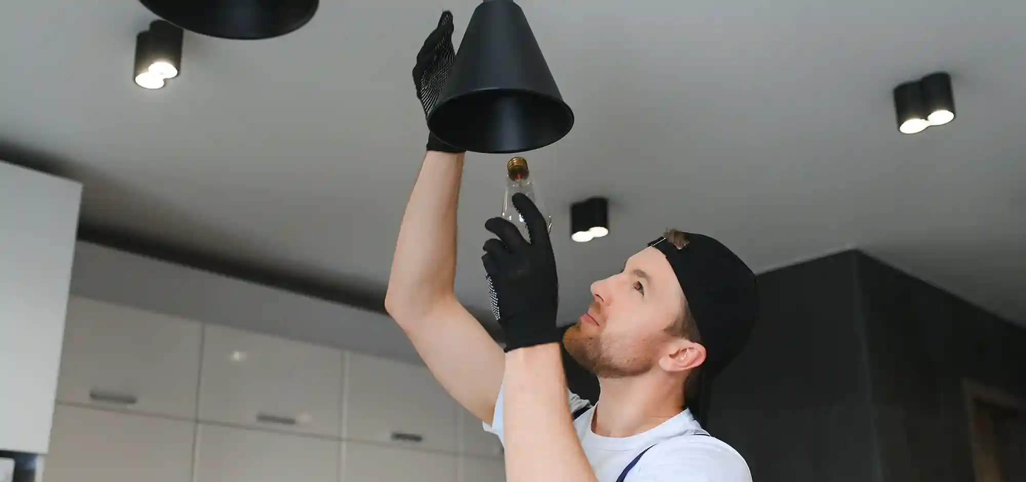 service_0004_male-electrician-changes-light-bulbs-ceiling-light-men-s-household-duties-care-electrical-appliances-home